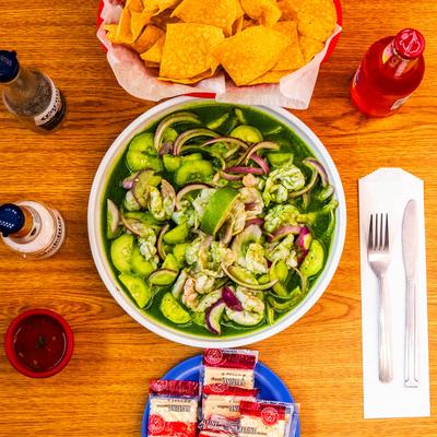 Green salad with cucumbers and tortilla chips.