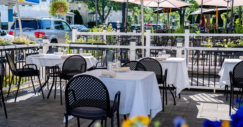 Outdoor dining area with set tables ready for guests