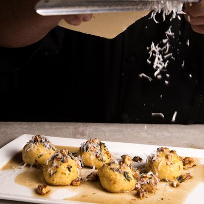 Dumplings with nuts and grated cheese.