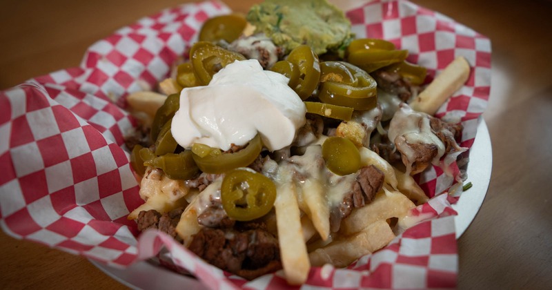 Loaded fries, with steak, cheese, sour cream, and jalapenos