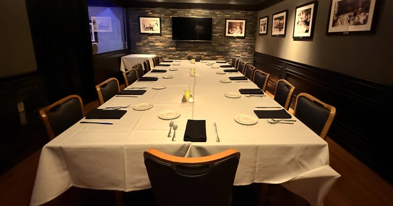 Conference style table. Showing stone wall and a 62 inch television for presentations.
