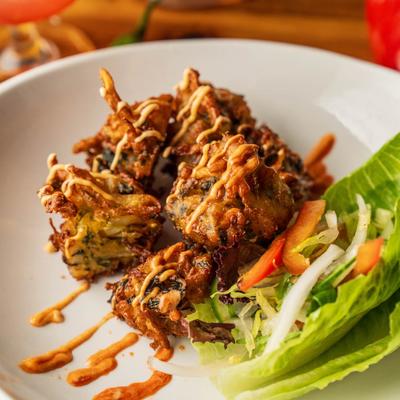 Deep fried vegetables with dynamite sauce.