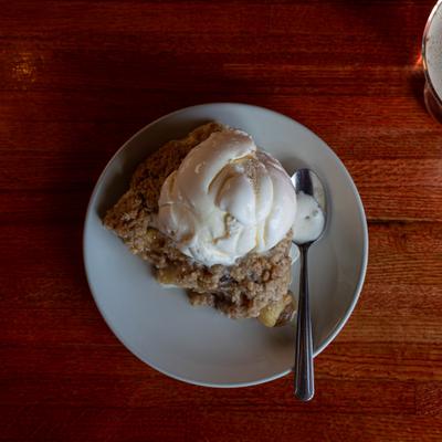 Apple Crisp topped with ice cream.