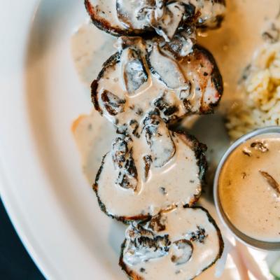 Pork tenderloin medallions smothered in a rich creamy mushroom sauce.