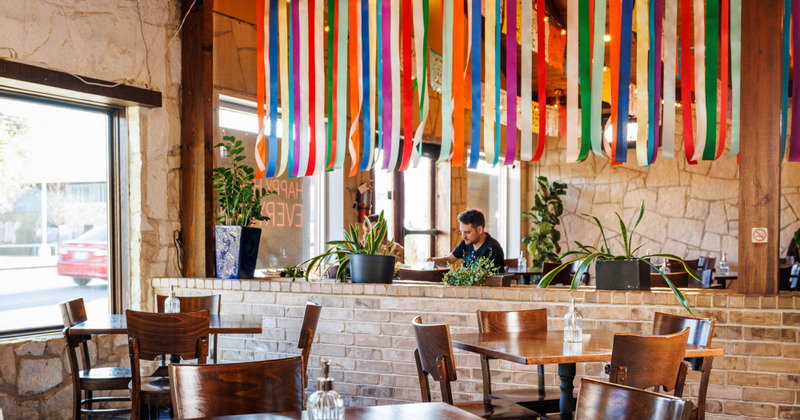 Interior, tables for four ready for guests