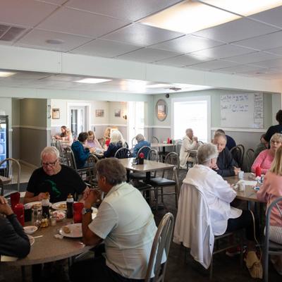 People dining in a busy restaurant.