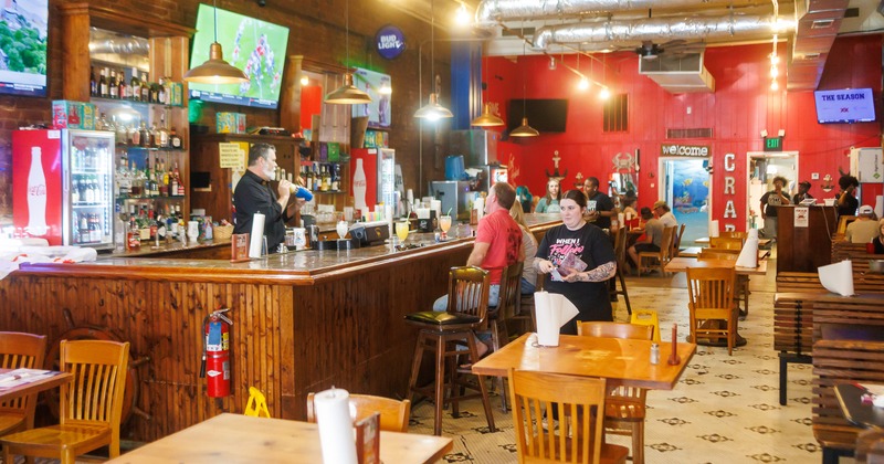 Interior space, bar area, and dining area with guests