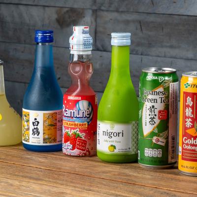 Various bottled drinks and canned beverages displayed on the table.