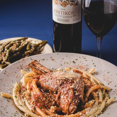 Pasta with lamb shank braised in wine and Roma tomato sauce