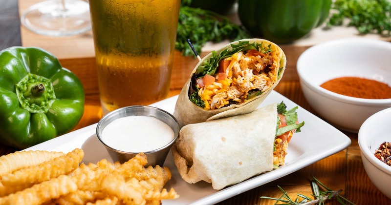 Buffalo Chicken wrap served with fries and a glass of beer