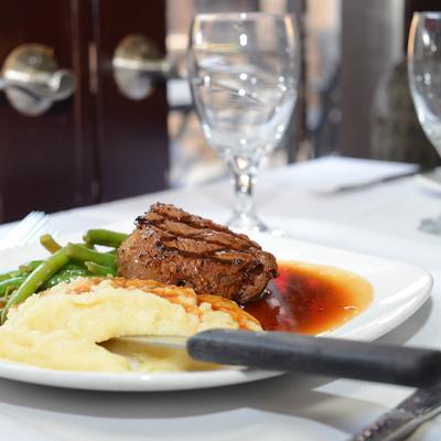 Filet Mignon, with mashed potatoes, green beans, and red wine sauce.