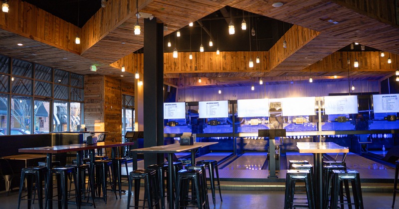 Specious and modern interior space with high tables and metal stools