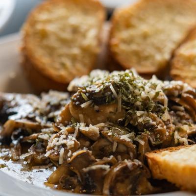 Sauteed mushrooms served with toasted bread, close up.