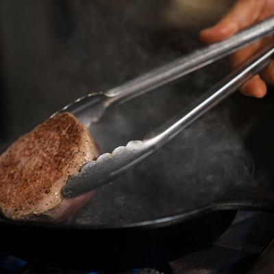 Chef grilling Filet Mignon.