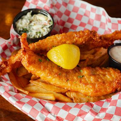 Fish and chips served with fries, tartar sauce, lemon, and apple gorgonzola slaw.