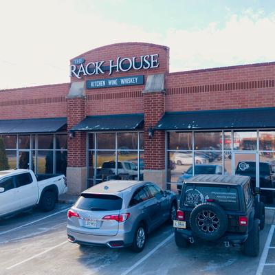 Restaurant parking lot with parked cars.