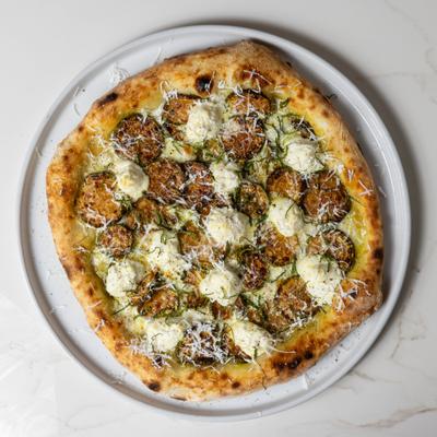 Pizza with zucchini and ricotta cheese.