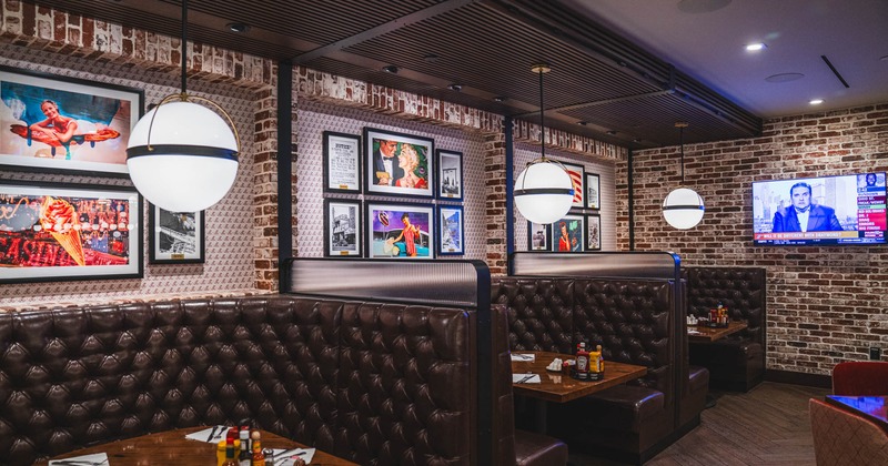 Interior, ''U'' shaped brown leather seating booths with tables, round chandeliers above