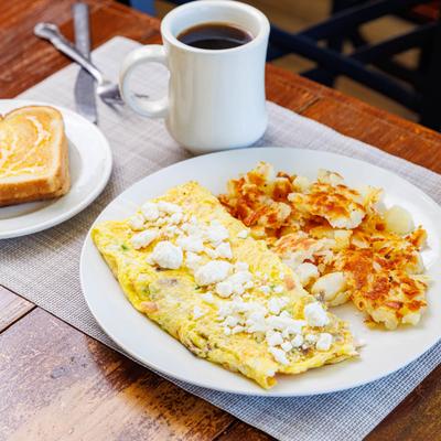 Omelet with cheese, hash browns, buttered toast, and coffee.