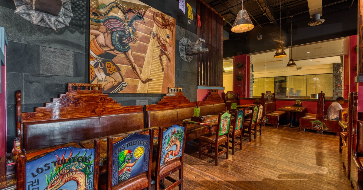 Interior seating area with wooden booths and colorful decor