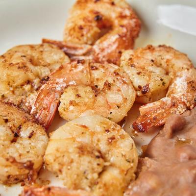 Shrimp cooked with butterand fresh garlic sauce, close-up.