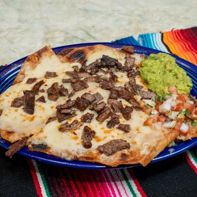 Carne Asada quesadilla served with guacamole and pico de gallo.