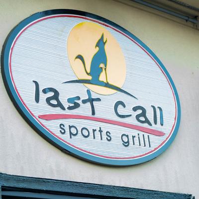 Business sign displaying name and logo.