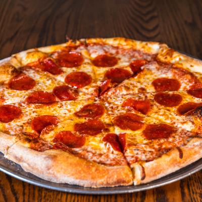 Pepperoni pizza on a wooden table.