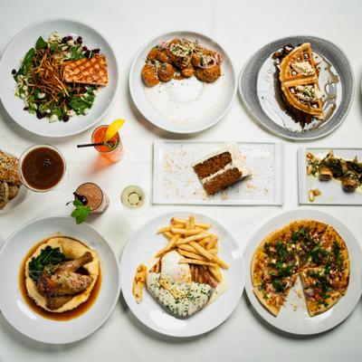 Assorted dishes and drinks on a table, top view.