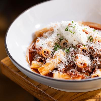 Braised short rib rigatoni pasta topped with Parmesan and herbs.