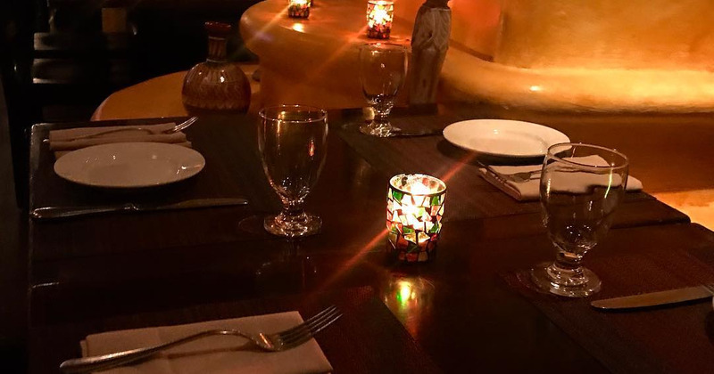 Interior, table with cutlery, dishes and glasses with candles