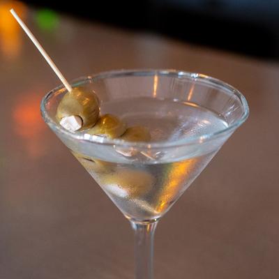 Classic Martini with green olive garnish.