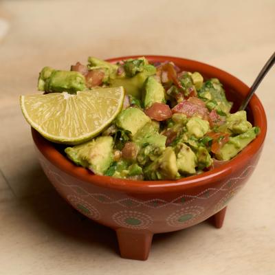 Fresh avocados chopped up with tomatoes, onions, cilantro, and lime juice.