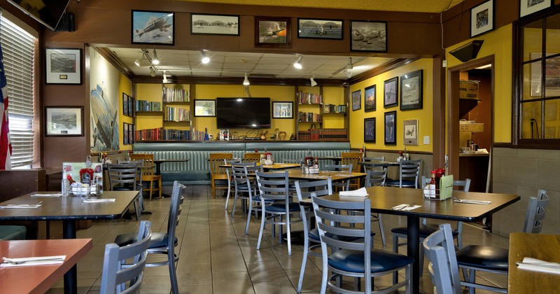 Cozy and spacious interior dining area with dining tables ready for guests