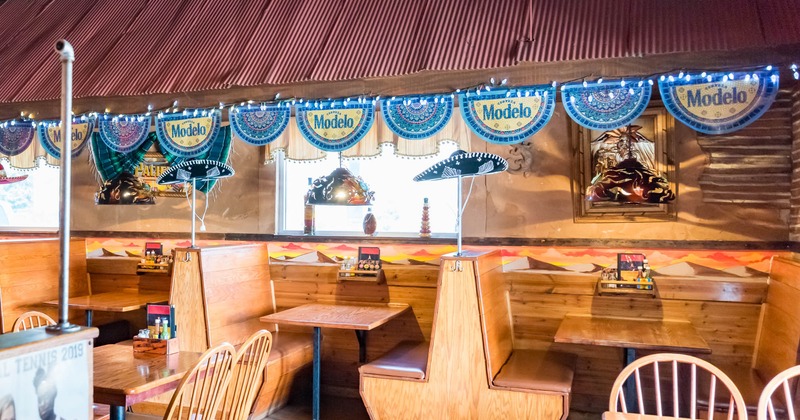 Interior, seating area with wooden stools, tables and chairs