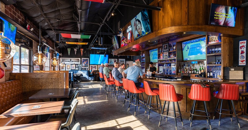 Interior, bar area with guests and staff at the bar