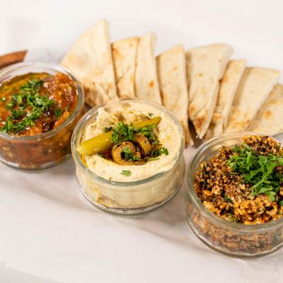 Hummus, tabbouleh, baba ghanoush, and pita bread.
