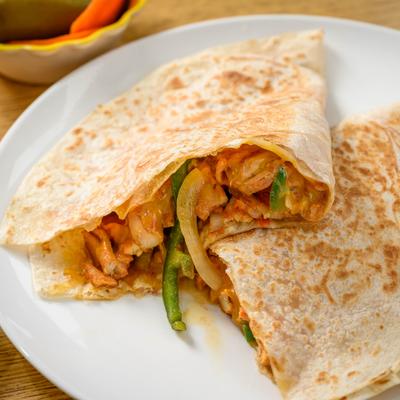 Chicken tortillas with grilled onions and bell peppers.