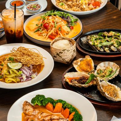 Assortment of Thai dishes displayed on a table.