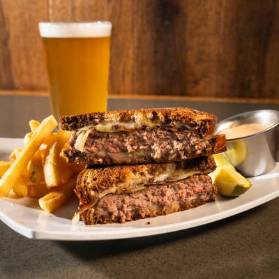Patty melt, served with fries, front view.