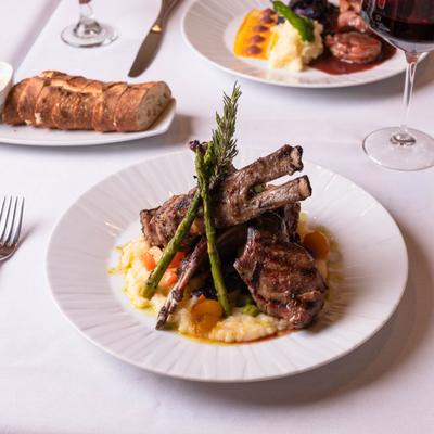 Grilled rack of lamb with Italian herb sauce, polenta and vegetables.