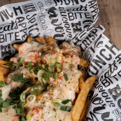 Loaded Cajun fries topped with cheese and green onion.