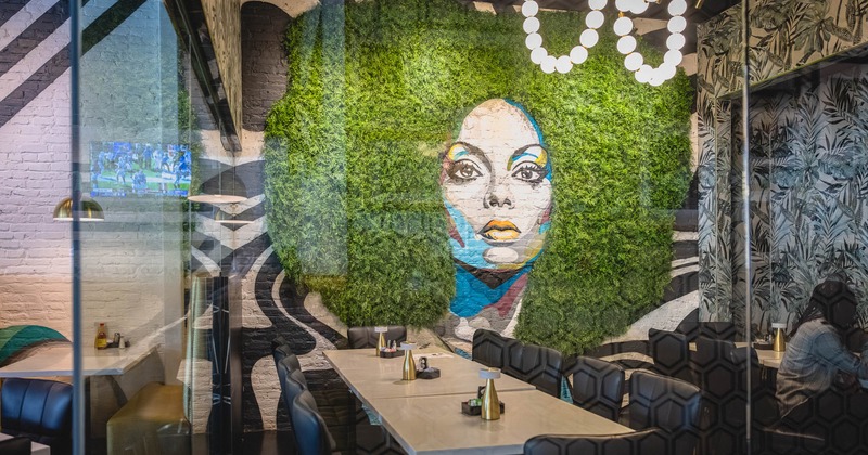 Dining table and a mural with fern