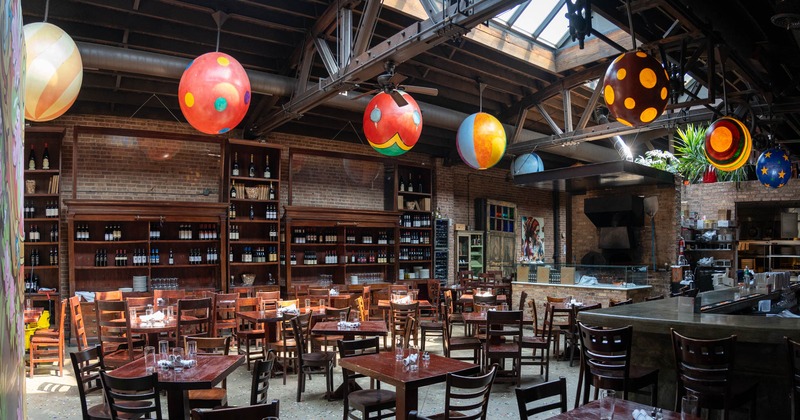 Interior, dining area with wine racks in the background