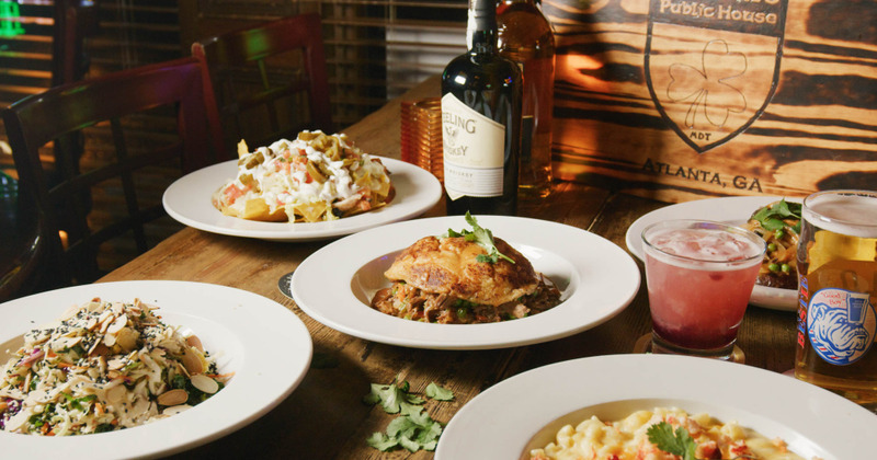 A table filled with bright colorful dishes and cocktails.