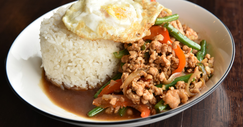 Dish of minced chicken, rice and veggies, topped with fried egg