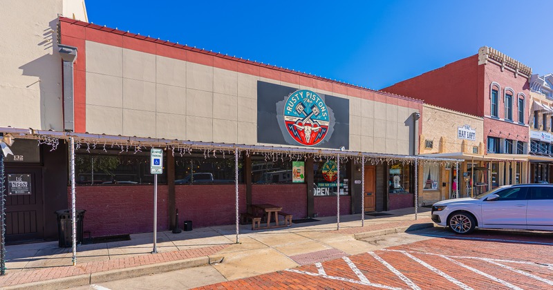 Exterior, front of restaurant, angle view, part of parking lot
