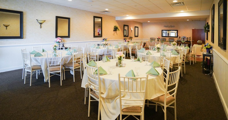 Banquet room with round tables covered with white cloths