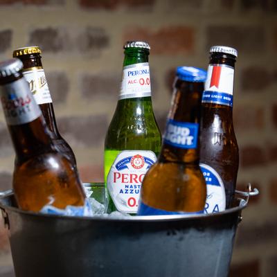 Ice bucket with several bottles of beer.