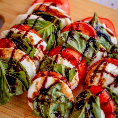 Caprese salad with tomatoes, mozzarella, basil and balsamic glaze.